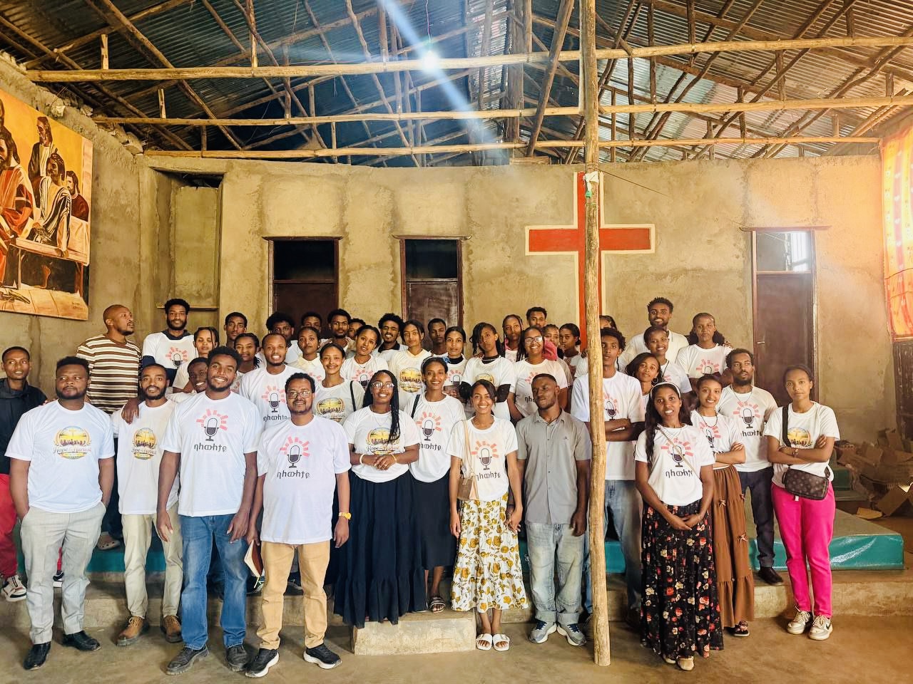 Volunteers holding Hope and Harvest Ministry t-shirts